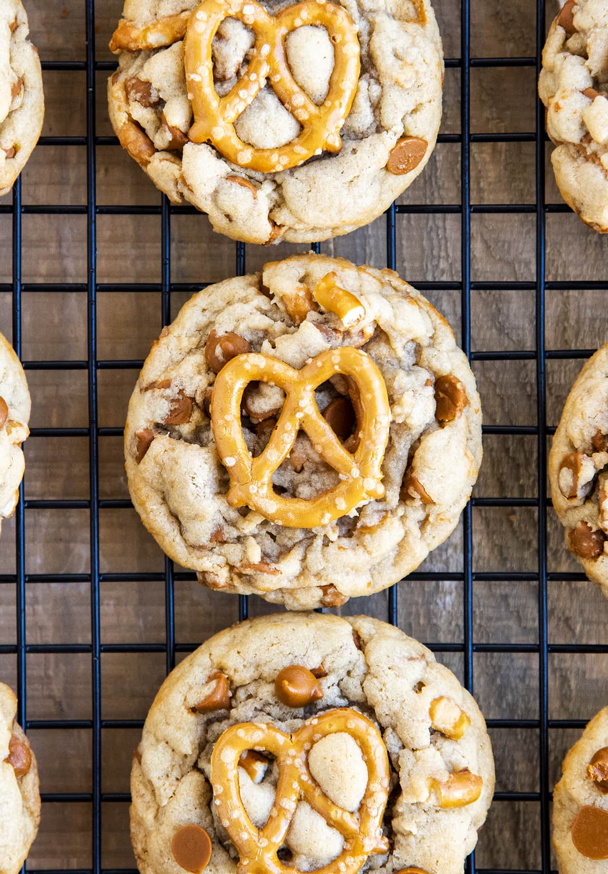 Pretzel cinnamon chip cookies on a cooling rack in a row.