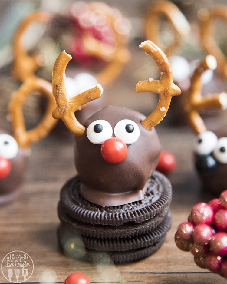 An oreo truffle decorated with candy eyes, a candy nose and pretzels to look like a reindeer. 