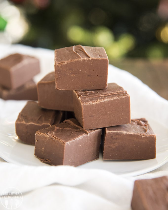A plate of chocolate fudge pieces, stacked up in a pile.