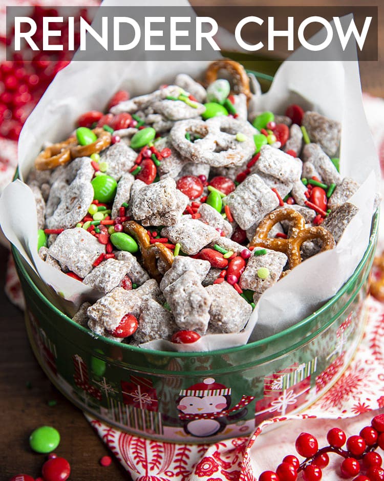 A bowl of Christmas muddy buddies with red and green m&m candies, and pretzels.