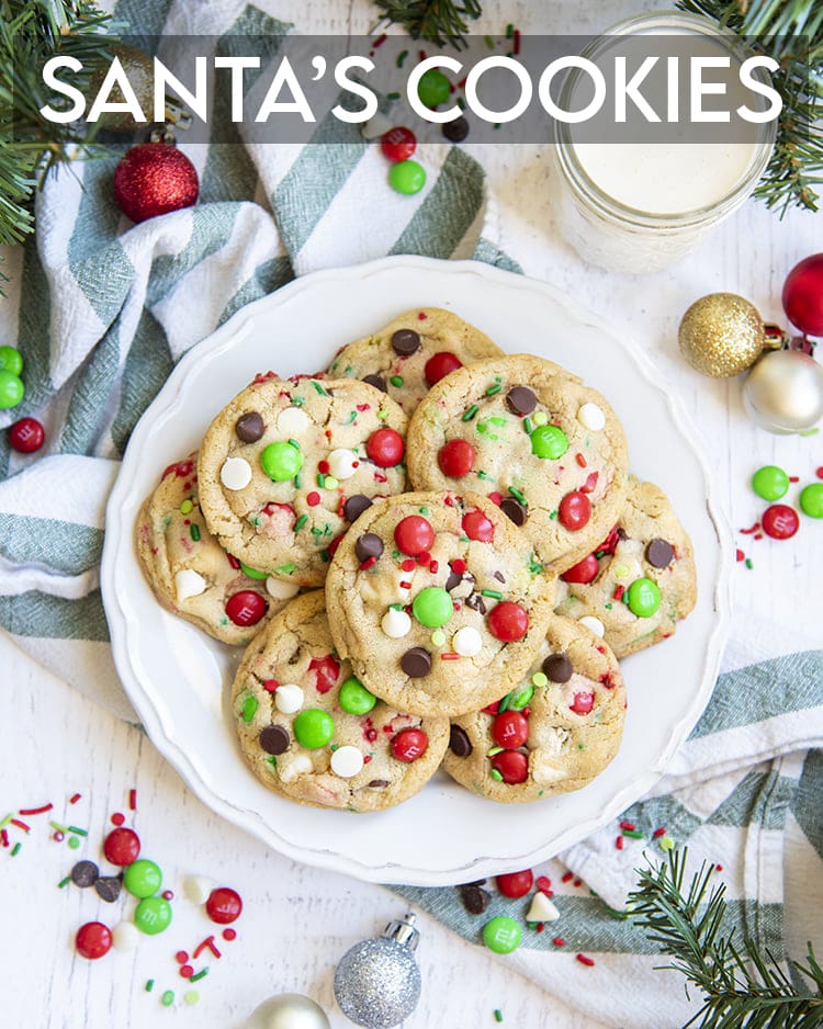 A plate of Christmas chocolate chip cookies with red and green m&ms and chocolate chips. 