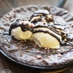 Angled view of skillet peppermint brownie with ice cream on top.