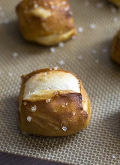 Front view of soft pretzel bites on a nonstick pan cover.