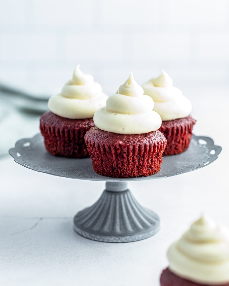 Red Velvet Cupcakes with Cream Cheese Frosting on a cake stand