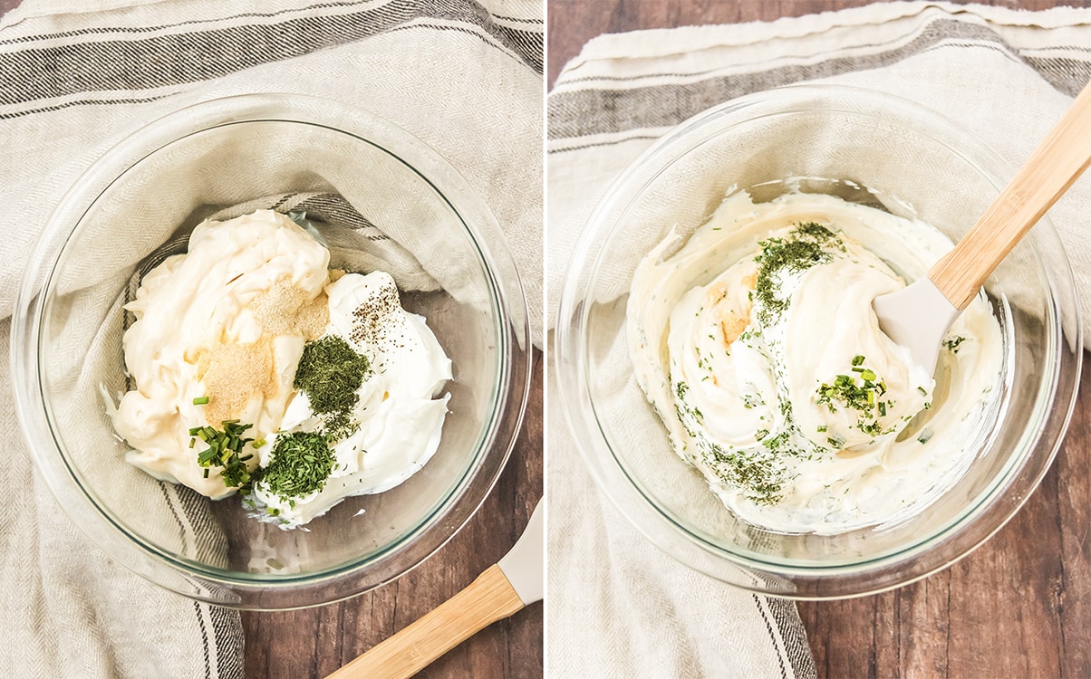 Ingredients for ranch dip being mixed inside of a glass bowl with a wooden spatula.