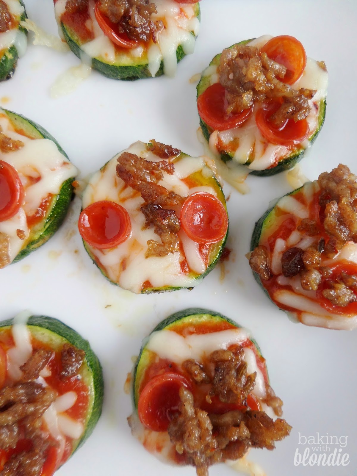 Top view of stuffed pizza peppers on a plate.