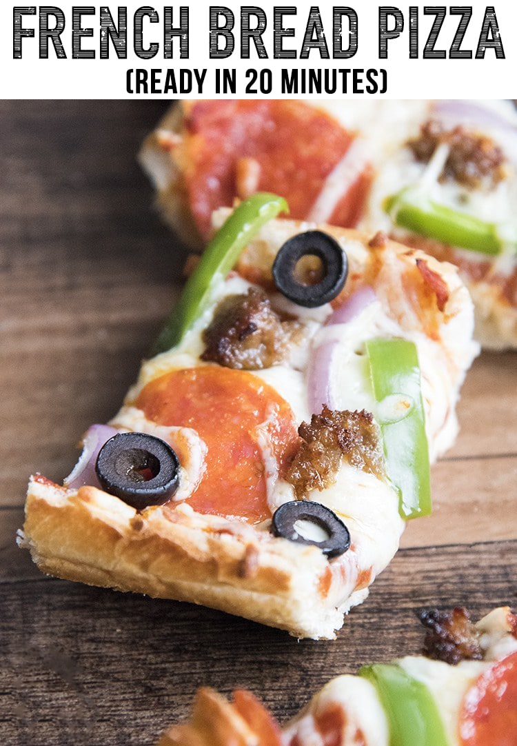 A slice of french bread pizza topped with sausage, pepperoni, and olives. 
