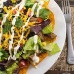 Top view of shredded beef taco salad on a white plate.