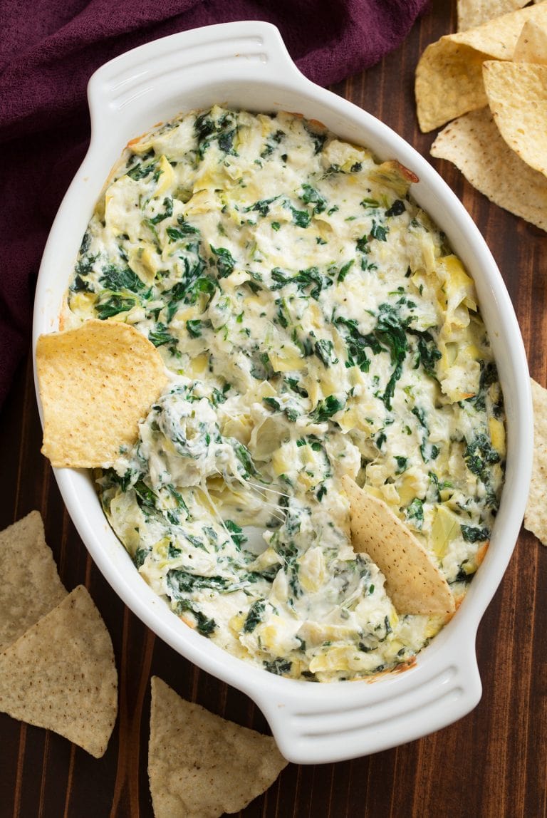Above view of spinach artichoke dip in a white bake pan.