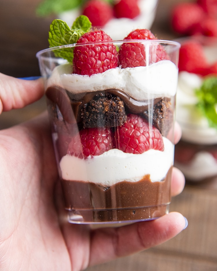 A side shot of the brownie trifle cup with each layer visible.