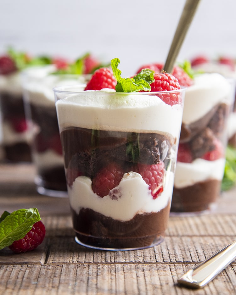 A side shot of the brownie trifle cup with each layer visible.