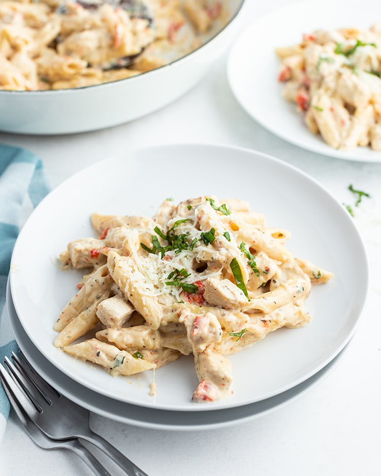 One Pan Cheesy Chicken Pasta on a dinner plate topped with parsley