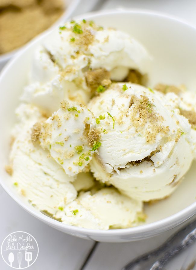 A bowl of key lime pie ice cream topped with graham cracker crumbs and lime zest. 