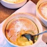 Angled view of lemon custard cake in small white bowls.