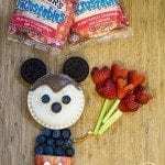 Top view of mickey mouse uncrustables food art on wood board.