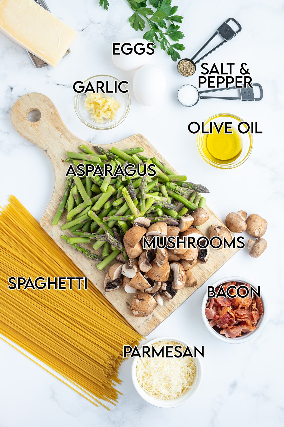 An overhead photo of the ingredients needed to make carbonara with asparagus.