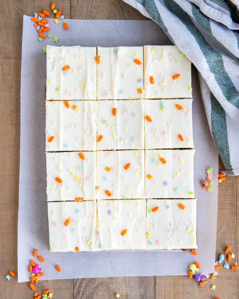 An above view of cookie bars topped with cream cheese frosting and Easter sprinkles.