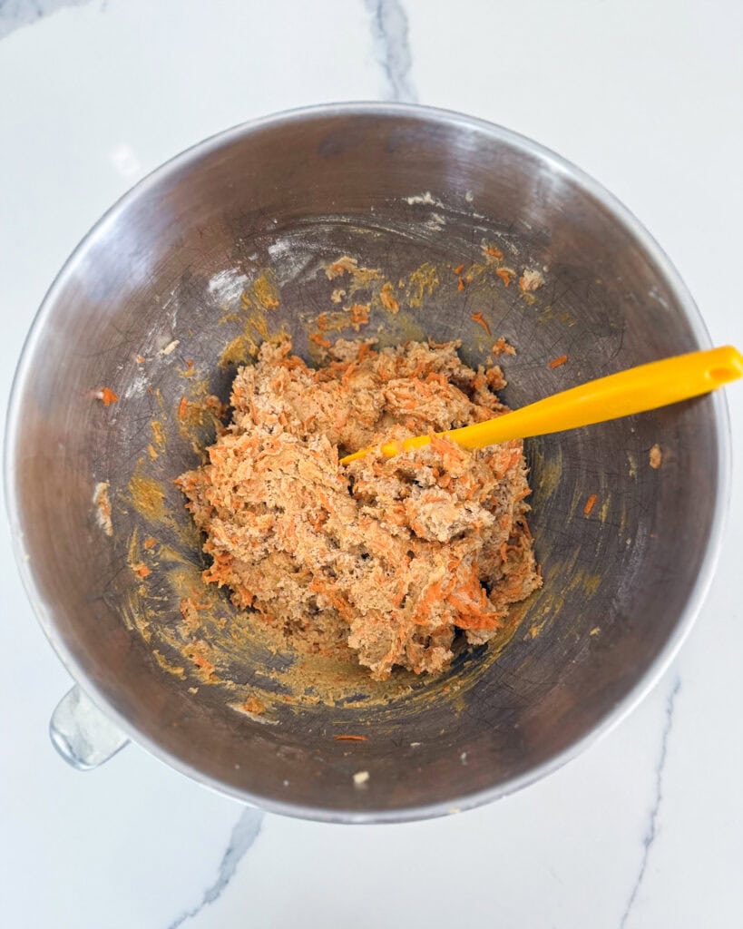 Carrot cake cookie batter in a bowl.