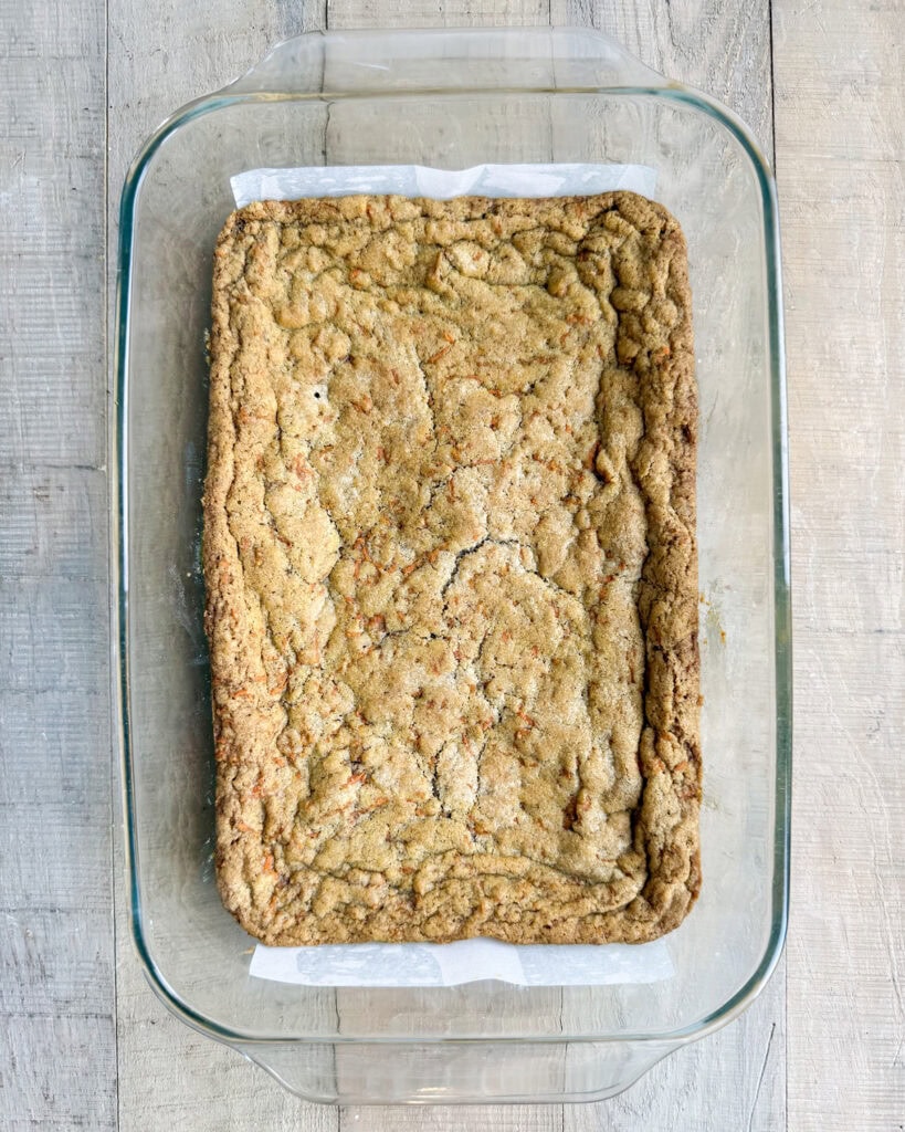 Carrot cake cookie bars in a glass pan.