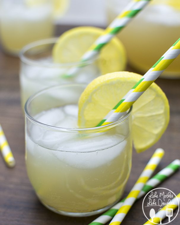 Front view of sparkling lemonade in glasses with straws.
