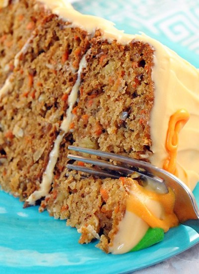 Angled view of 14k cake on a plate with a fork.