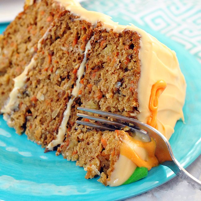 Angled view of 14k cake on a plate with a fork.