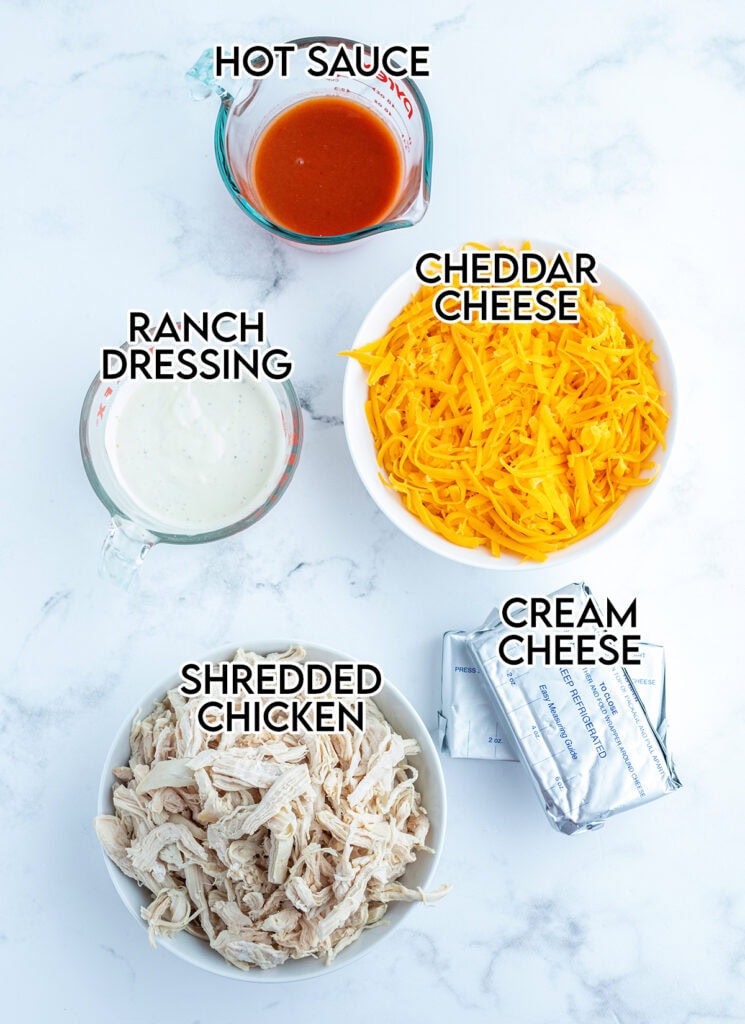 An above view of the ingredients needed to make buffalo chicken dip.