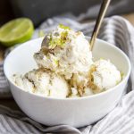 A bowl of key lime ice cream topped with lime zest.