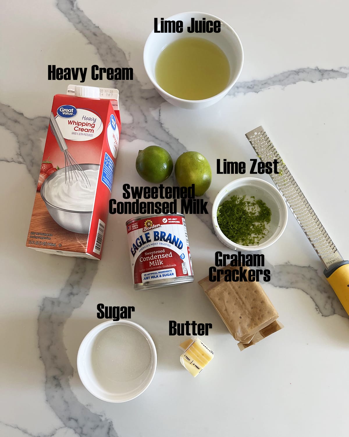 The ingredients needed to make key lime pie ice cream with labels on them.