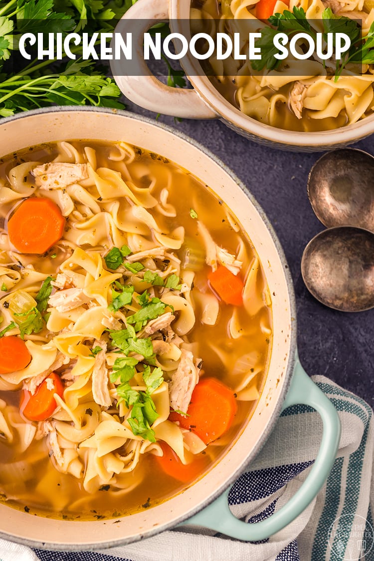 Above image of chicken noodle soup in white bowls with ingredients surrounding them.