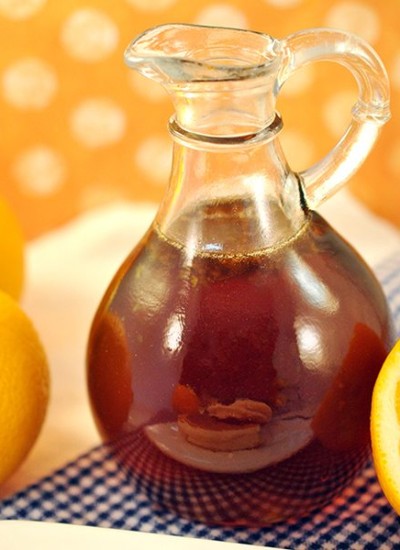 Close up of orange zest syrup in a glass jar.