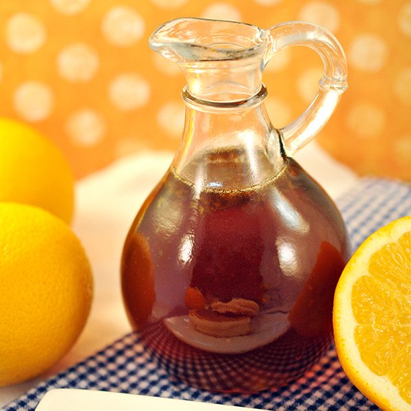 Close up of orange zest syrup in a glass jar.