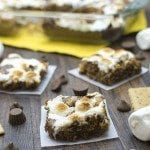 Front view of smores peanut butter cookie bars on a wood board.