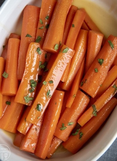 A pile of sweet glazed carrots in a dish.