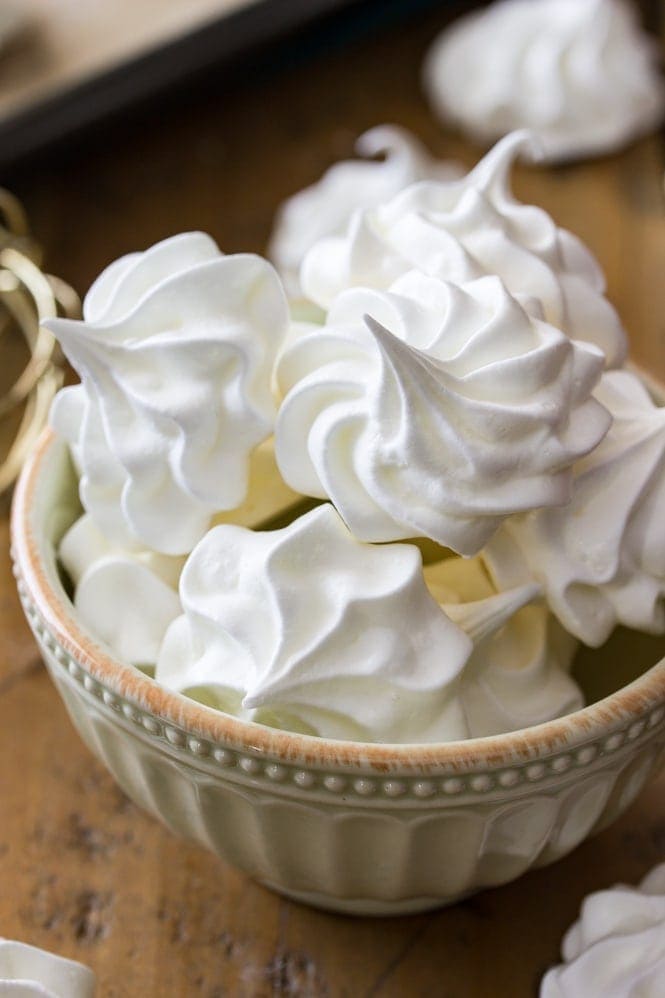 A bowl of white meringue cookies.