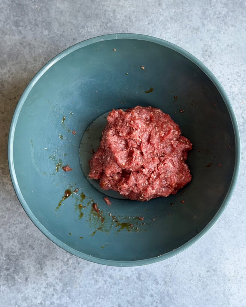 Seasoned ground beef in a bowl. 