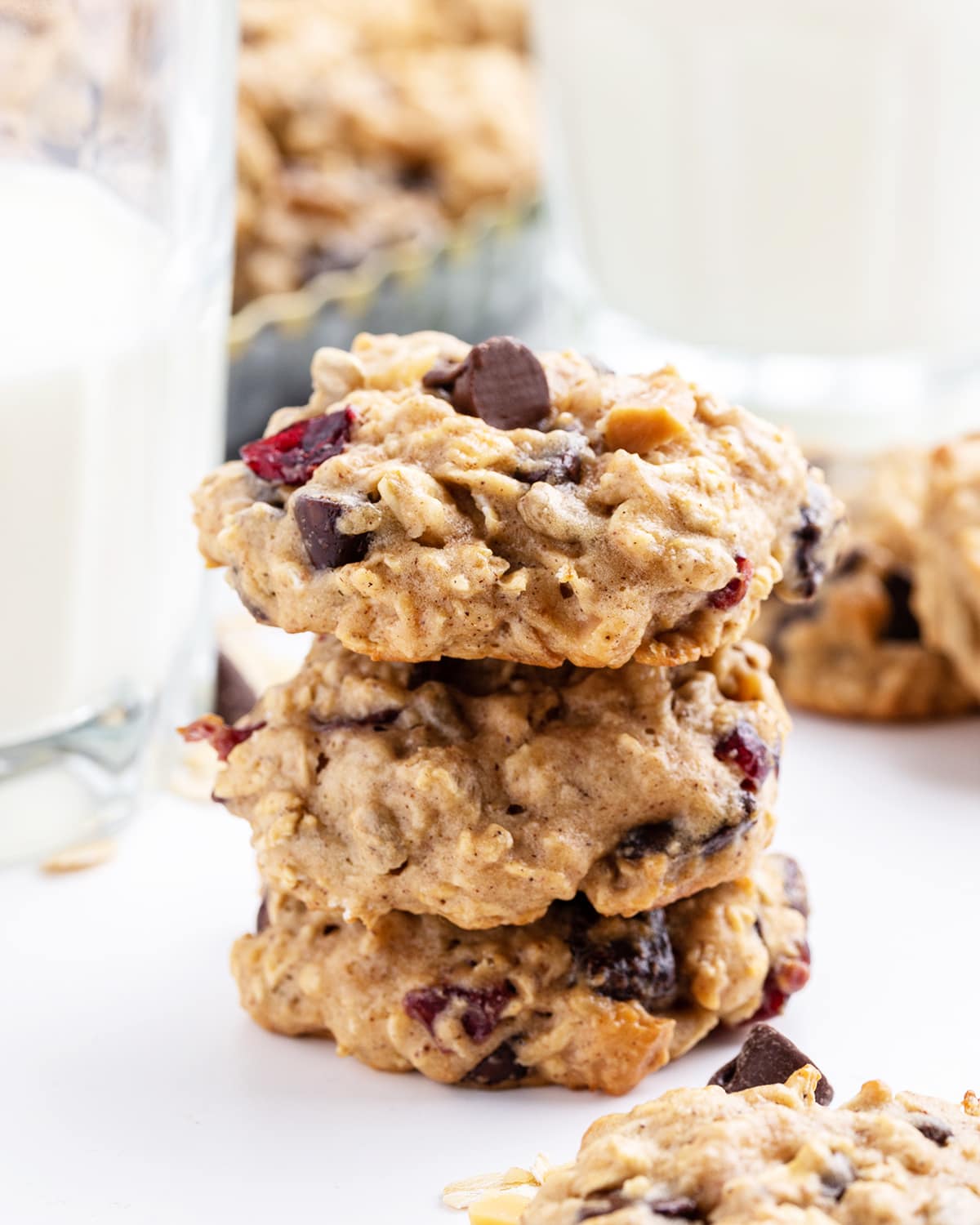 A stack of 3 hurricane cookies, they are loaded with oats, chocolate chips, and craisins.