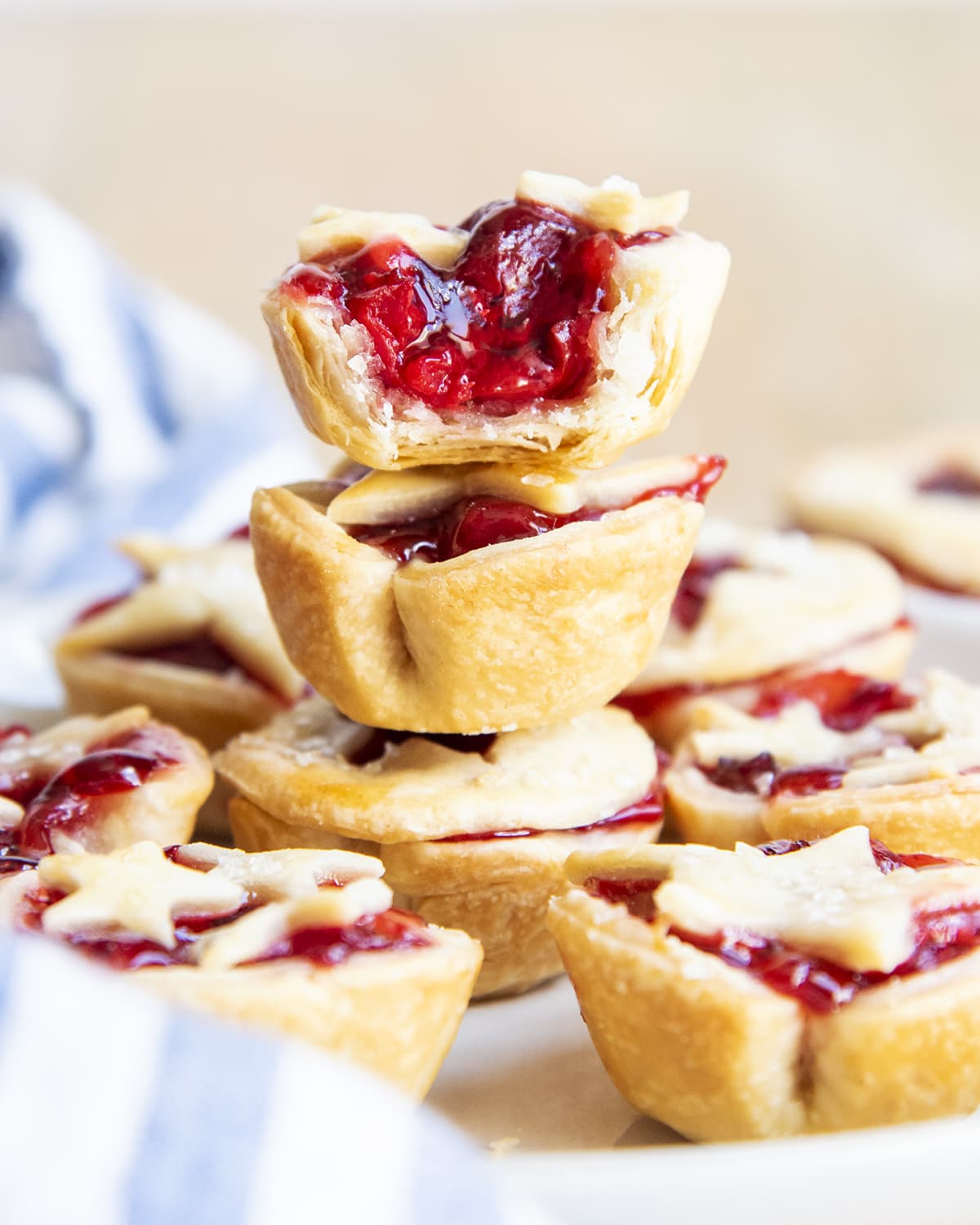 A stack of three mini cherry pies, with the top showing the middle of the pie.