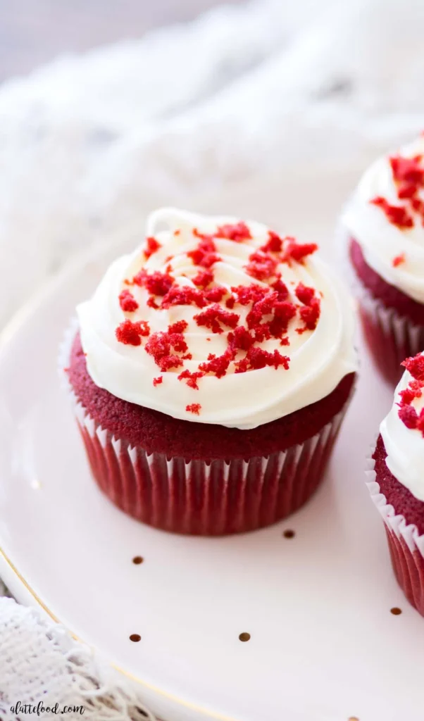 A red velvet cupcake on a plate. 