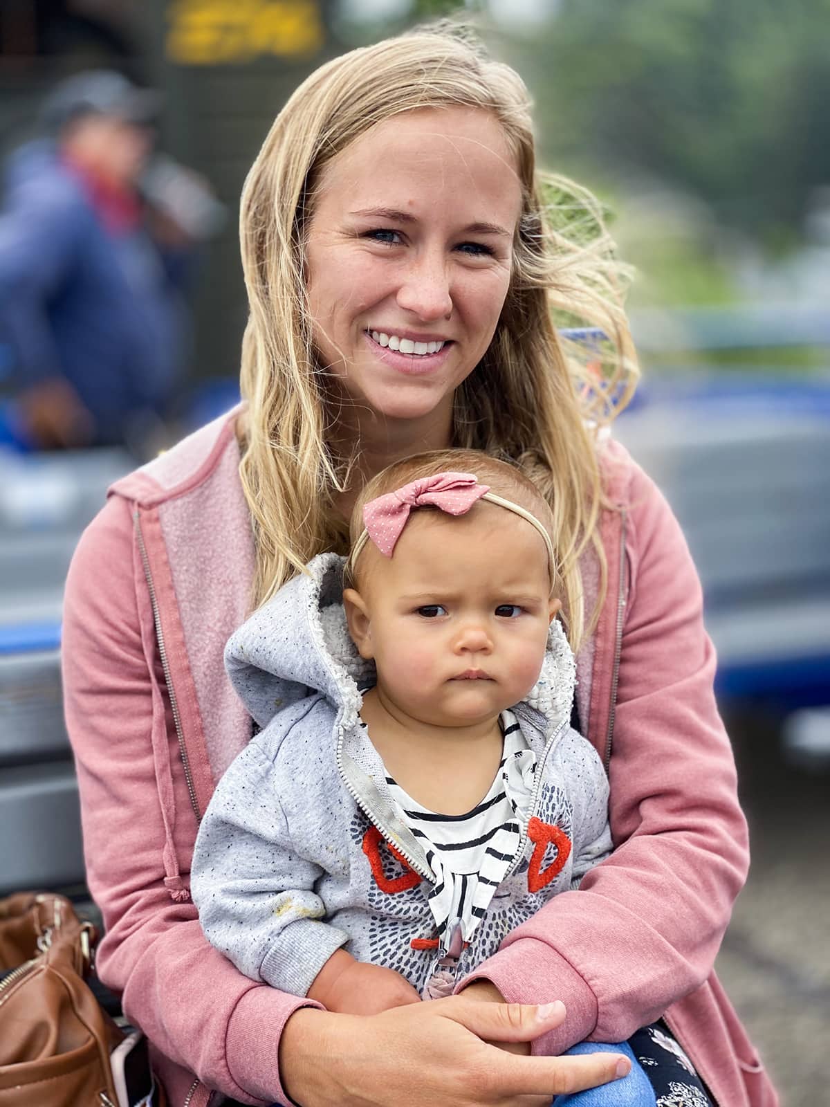 A woman and a baby sitting on a train. 