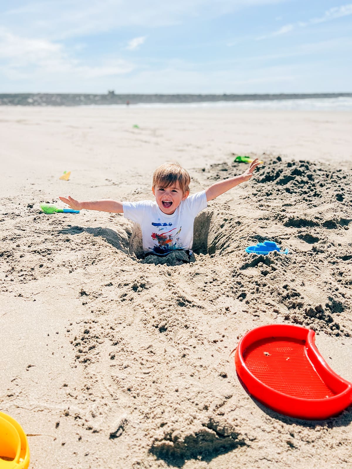 A small bowl sitting in a hole at the beach.