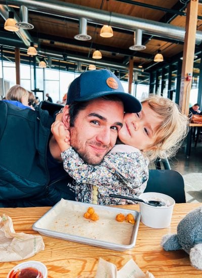 A little girl hugging her dad at the Tillamook Creamery.