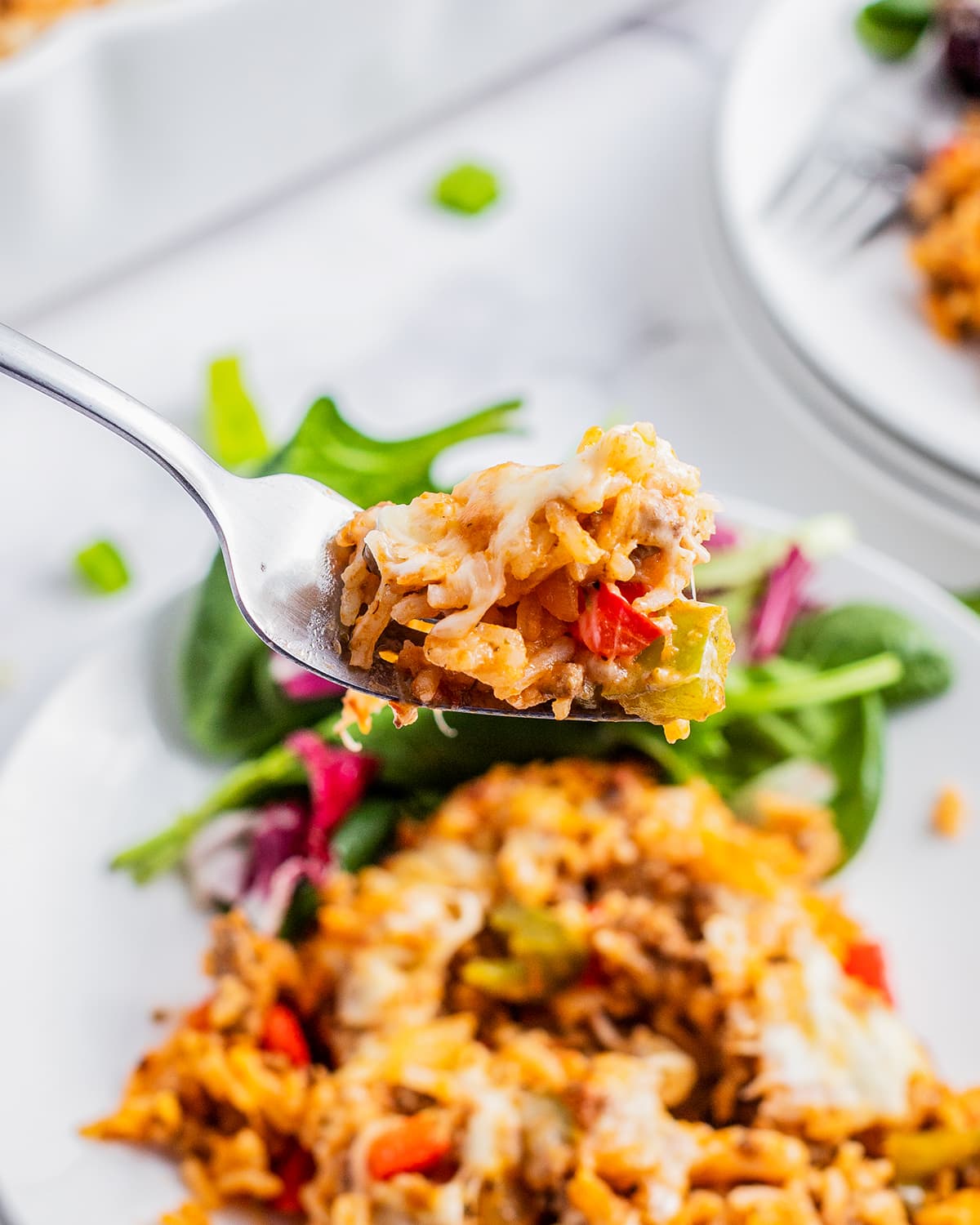 A forkful of stuffed pepper casserole.