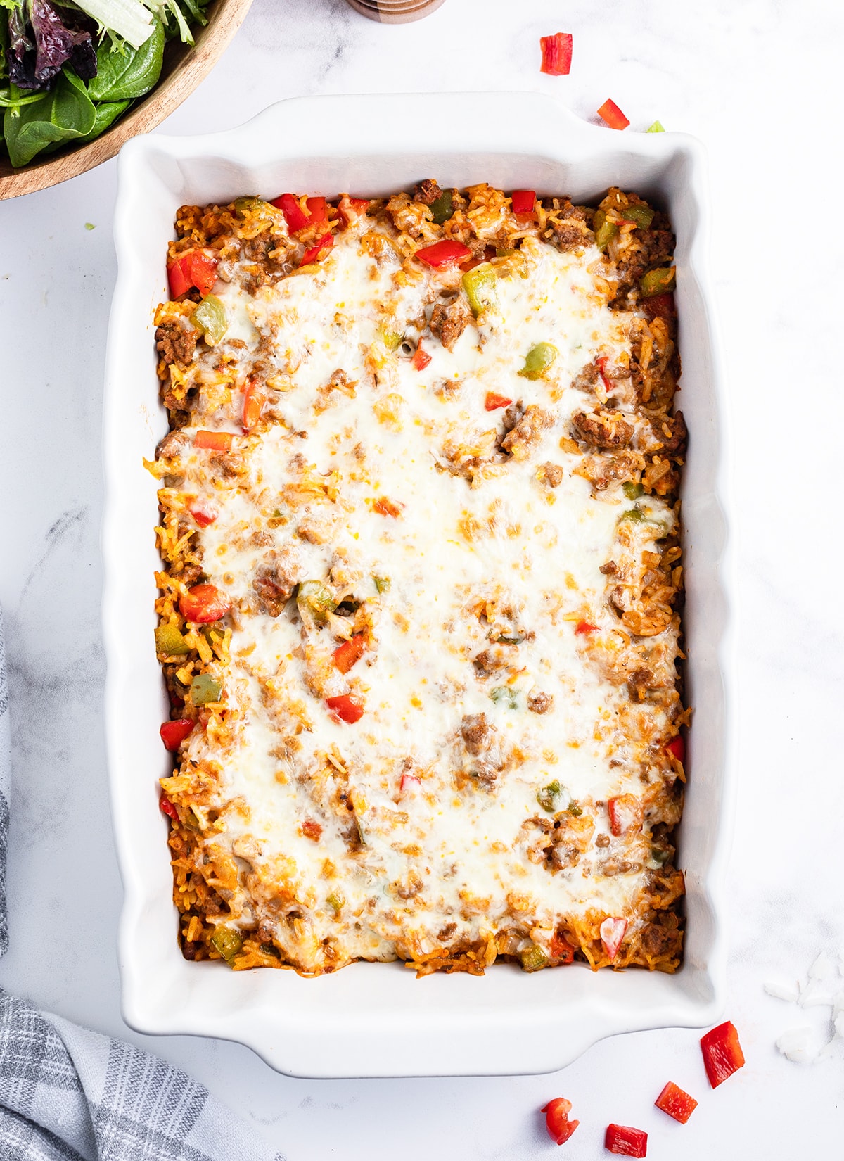 An overhead photo of a stuffed pepper casserole in a white baking dish.