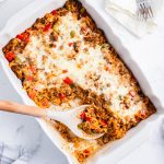 An overhead photo of stuffed pepper casserole with some scooped out of the dish.