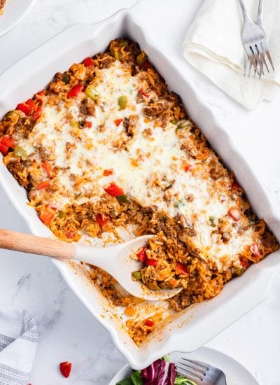 An overhead photo of stuffed pepper casserole with some scooped out of the dish.