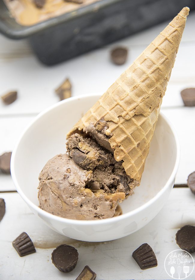 An upside down chocolate ice cream cone with swirls of peanut butter, and a sugar cone on top. 