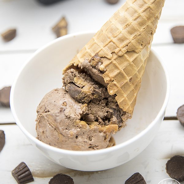 Close up view of a scoop of no churn chocolate peanut butter cup ice cream cone in a bowl.