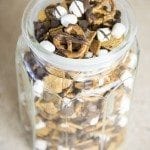 Angled view of a smores snack mix in a mason jar.