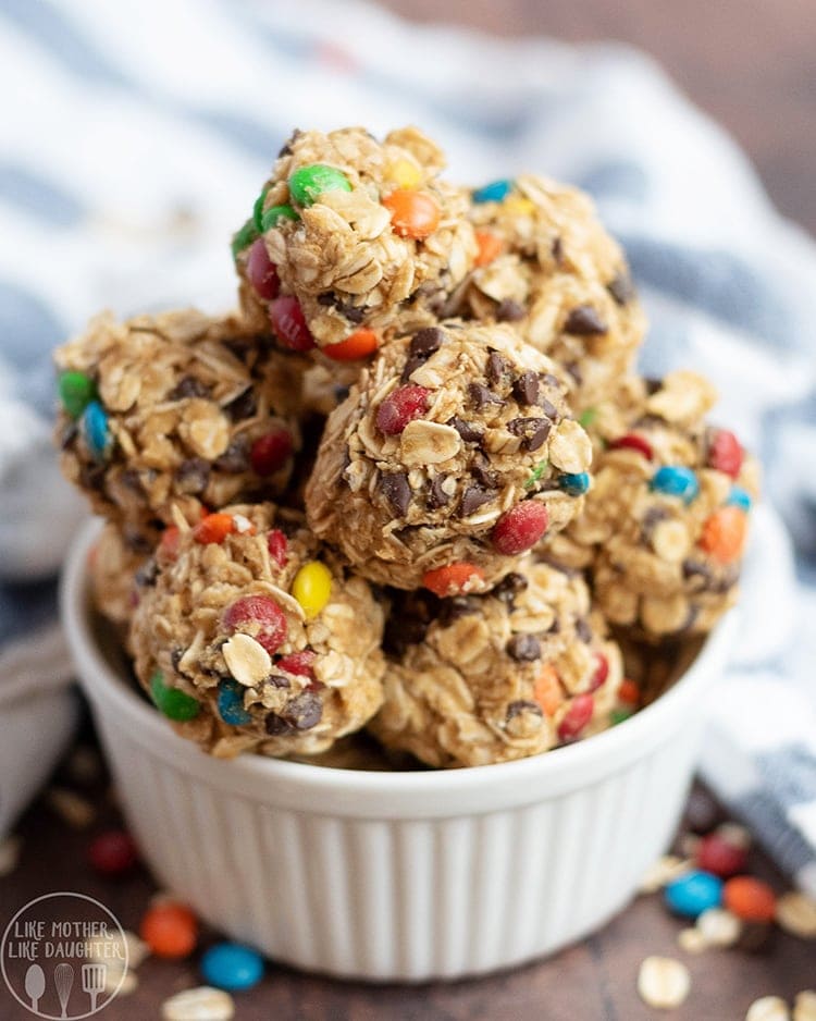 Close up image of monster granola bites with oats and m&m's in a small white ramekin.